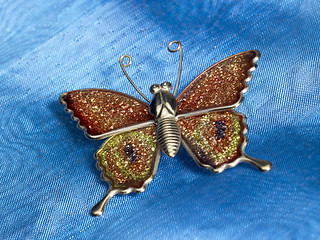 Image showing butterfly trinket ob blue fabrics