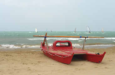 Image showing red catamaran at the beach