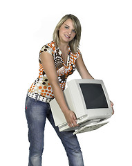 Image showing cute girl carrying a computer monitor