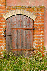 Image showing Abandoned farm house door lock red brick building