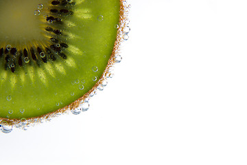 Image showing Close-up of a kiwi slice with bubbles 