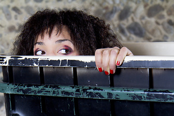 Image showing Woman in a trash container