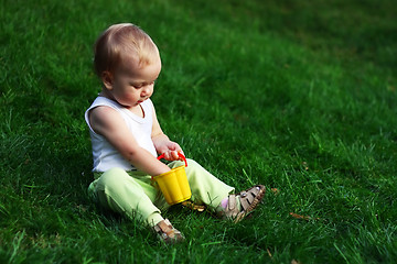 Image showing Little boy on a green grass