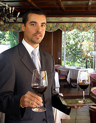 Image showing Butler is serving wine