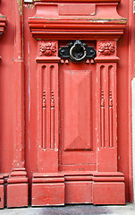 Image showing Vintage red wooden door with metal handle backdrop 