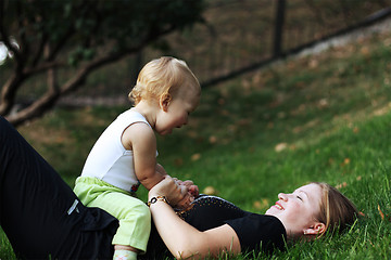 Image showing Mother with sone play on a grass