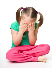 Image showing Little girl is sitting on floor and crying