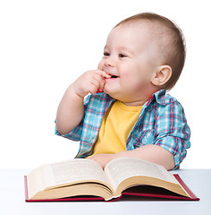 Image showing Little child play with book