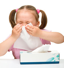 Image showing Little girl blows her nose