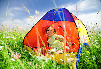 Image showing Girl is playing outdoors under tent
