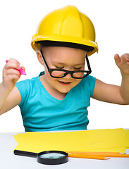 Image showing Cute little girl draw with marker wearing hard hat