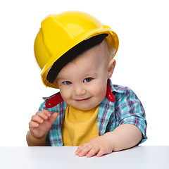 Image showing Cute little boy wearing oversized hard hat