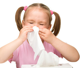 Image showing Little girl blows her nose