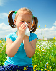 Image showing Little girl is blowing her nose