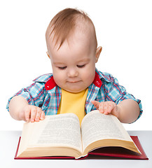 Image showing Little child play with book