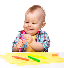 Image showing Happy little boy is playing with colorful markers