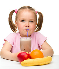 Image showing Little girl drinks fruit juice