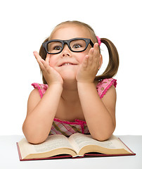 Image showing Little girl play with book