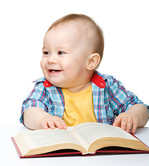 Image showing Little child play with book