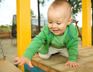 Image showing Little boy is playing on playground