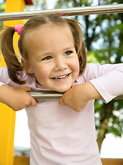 Image showing Little girl is playing in playground