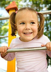 Image showing Little girl is playing in playground