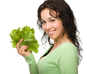 Image showing Beautiful young girl with green lettuce leaf