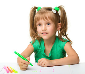 Image showing Cute little girl draws with markers