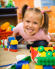 Image showing Little girl is playing with toys in preschool