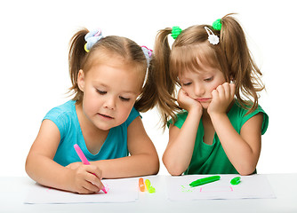 Image showing Two little girls draw with markers