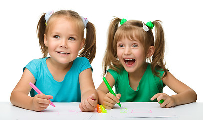 Image showing Two little girls draw with markers