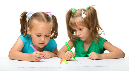 Image showing Two little girls draw with markers