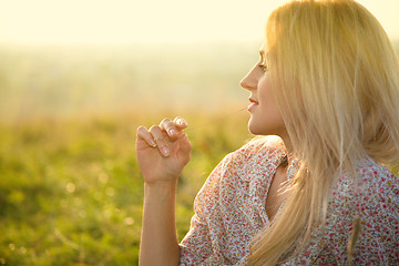 Image showing Girl is relaxing on green field