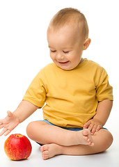 Image showing Cheerful little boy with red apple