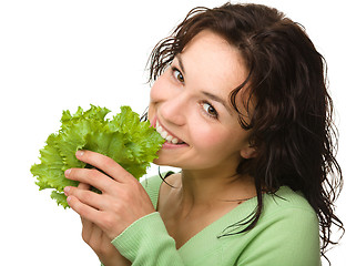 Image showing Beautiful young girl with green lettuce leaf