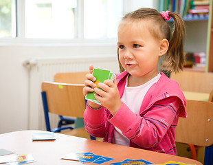 Image showing Cute little girl is playing with educational cards