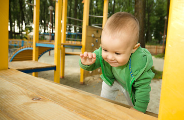 Image showing Little boy is playing on playground