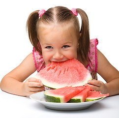 Image showing Cute little girl is going to eat watermelon