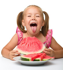 Image showing Cute little girl is going to eat watermelon