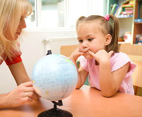 Image showing Little girl at geography lesson