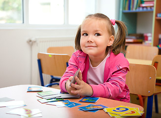 Image showing Cute little girl is playing with educational cards