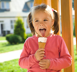 Image showing Little girl is eating ice-cream