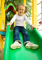 Image showing Cute little girl is playing on slider