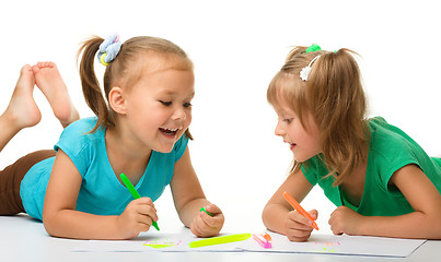 Image showing Two little girls draw with markers