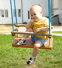 Image showing Cute little boy on swing