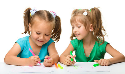 Image showing Two little girls draw with markers