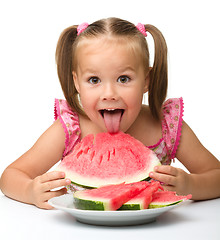 Image showing Cute little girl is going to eat watermelon