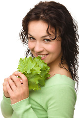 Image showing Beautiful young girl with green lettuce leaf