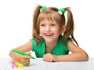 Image showing Cute little girl draws with markers