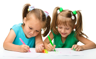 Image showing Two little girls draw with markers